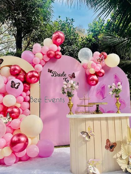 Another angle of the butterfly-themed "Bride to Be" setup. The outdoor setting and the soft pink color palette create a fresh and beautiful environment for a daytime celebration.