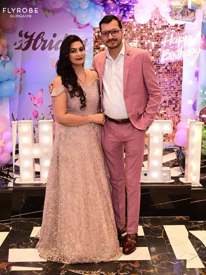 A happy couple at a party. She is wearing a beautiful sequined gown, showing that you can find the perfect partywear for any event.