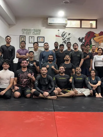 The team celebrating a huge milestone together. Earning a new belt is a personal achievement, but it's celebrated by the entire community. This is the brotherhood we've built at Crosstrain Fight Club.