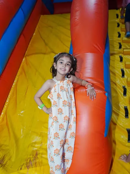 Whoosh! A young girl poses at the top of one of our giant inflatable slides before taking the plunge. It's a thrilling ride from top to bottom every single time.