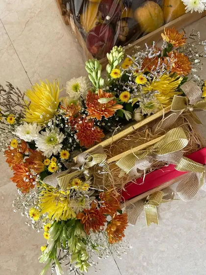 Another angle of the vibrant floral platter for a wedding, showing how the flowers beautifully envelop the gifts.