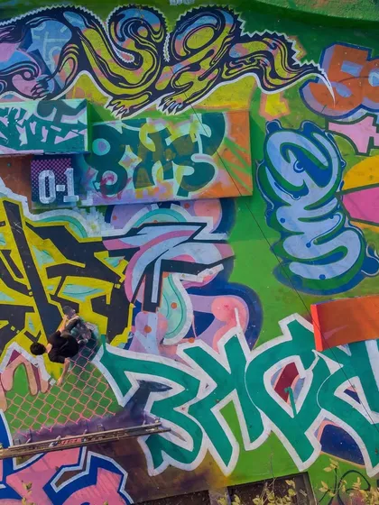 A close-up detail of the finished mural, showing the textures and layers created by different artists' styles overlapping and interacting.