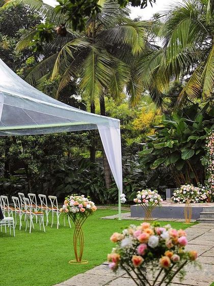 A collection of stunning wedding setups at The Farmhouse Collective. You can see the venue's versatility, from elegant morning ceremonies with floral mandaps to glamorous evening receptions with fairy lights and chic decor. This space is a blank canvas for your dream outdoor wedding in Bengaluru.