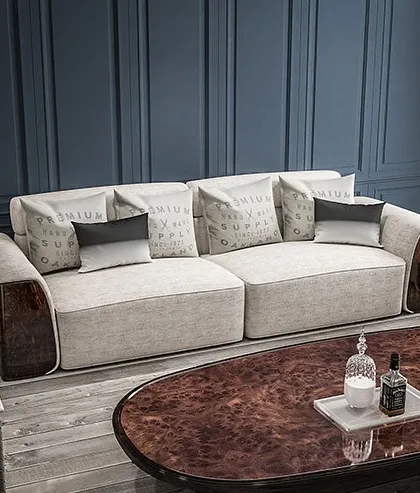Sink into luxury with this exquisite sofa. Its plush, light-colored fabric contrasts beautifully with the dark, polished wood arms, creating a stunning centerpiece for your living room.