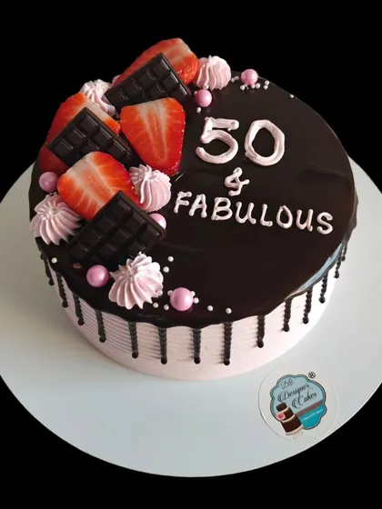 A "50 & Fabulous" chocolate and strawberry cake. The rich chocolate glaze and fresh strawberries make for a decadent and celebratory dessert.