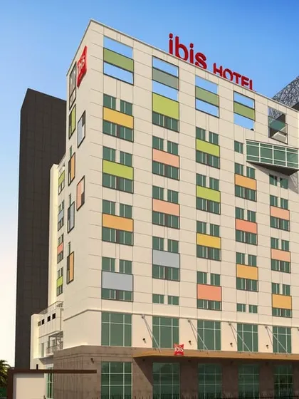 A daytime render of the IBIS Hotel in Thane. The design features a clean, gridded facade with colorful panels, reflecting the brand's vibrant and efficient approach to hospitality.