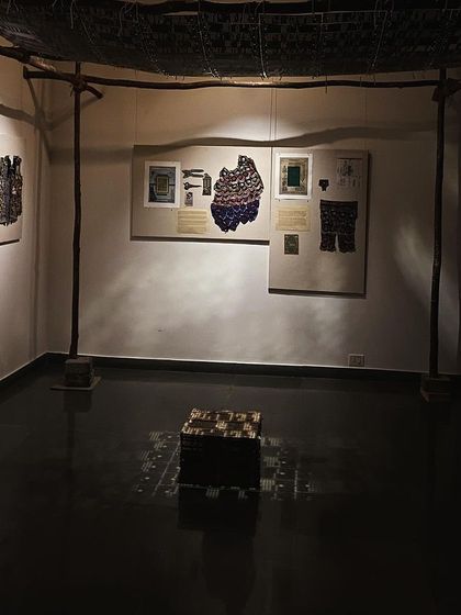 A corner of the 'WEAVING LIGHT' installation, showing the moody, atmospheric lighting.