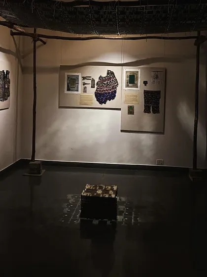 A corner of the 'WEAVING LIGHT' installation, showing the moody, atmospheric lighting.