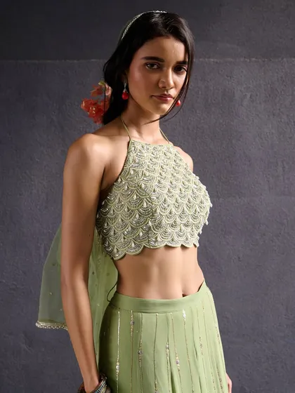 A beautiful mint green halter-neck blouse with intricate pearl and bead embroidery. This piece from the Anam Cara collection is perfect for a summer wedding.