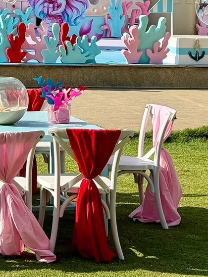 A side view of the themed tables set up on the lawn, ready for the little guests.