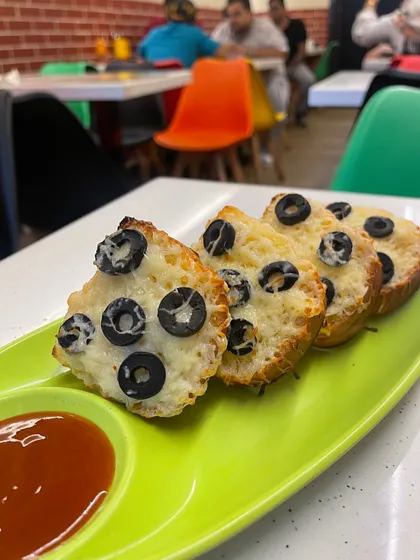 My Olive Cheese Garlic Bread is a delicious twist on a classic. It's topped with cheese and black olives, then baked to perfection.