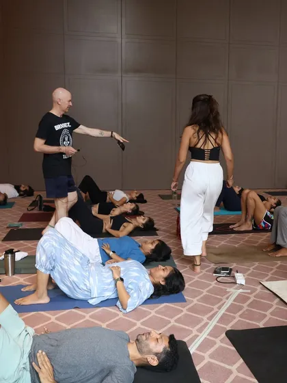Assisting my teacher, Eddie Stern, during a workshop. It is an honor to help guide students through practices that calm the nervous system, like this restorative pose.
