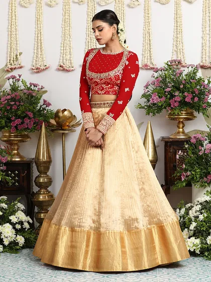 A poised and elegant shot of the red and beige lehenga, perfect for a bride's pre-wedding festivities.