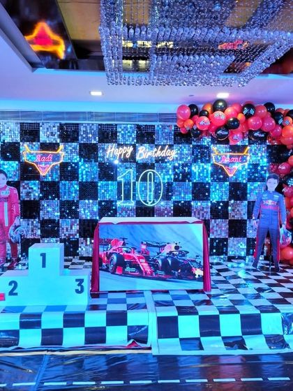 A slightly different angle of the impressive F1 racing theme, highlighting the crystal chandelier above the race-ready stage.