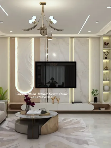 The TV unit in the Pune project, featuring a clean design with a marble back panel, a floating console, and backlit display shelves.