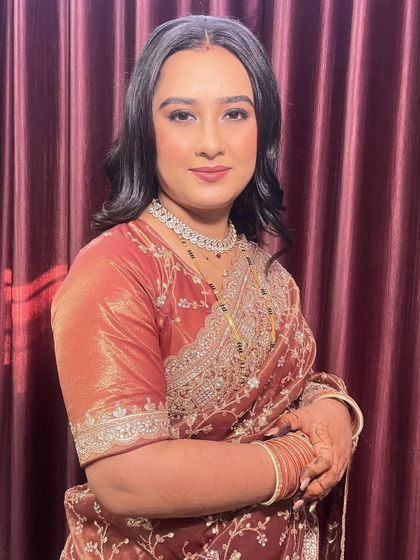 Another lovely shot of the bride's reception look. The soft makeup and elegant styling create a timeless and beautiful finish.