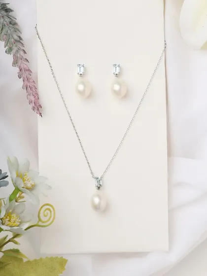 The complete Blue Topaz and Pearl set. This pairing of earrings and necklace feels like it was made just for you, impossible to forget.