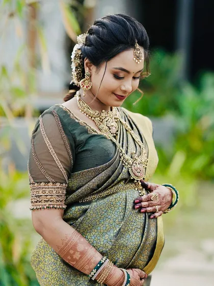 The serene glow of a mother-to-be is priceless. Here, my intricate henna work beautifully complements her joy as she looks down at her baby bump during her baby shower photoshoot.