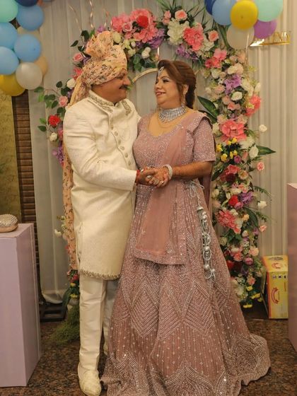 A beautiful couple celebrating their anniversary in my rental outfits. Her dusty pink lehenga and his ivory sherwani create a perfectly coordinated and elegant look.