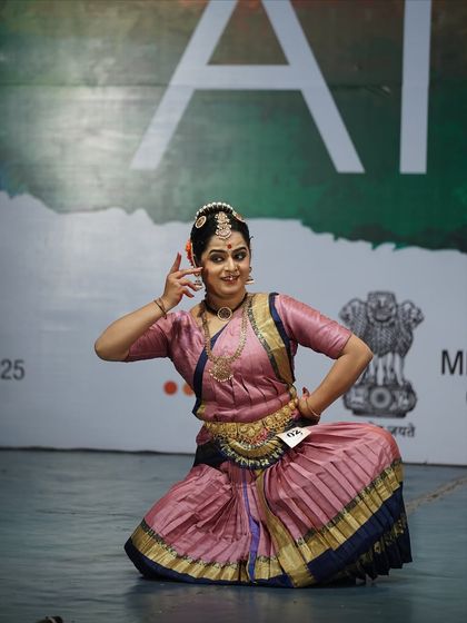 A student in a graceful sitting posture, her expressive face telling a story. Her performance earned her a 2nd place award in the open category.