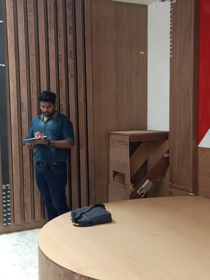 Our architect on-site, taking notes and ensuring every detail of the bedroom, including the circular bed design, is executed according to the plan.