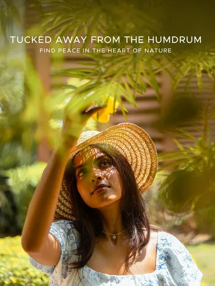 Find peace in the heart of nature. A guest wearing a straw hat gently touches a leaf, embodying the deep connection with the natural world that we encourage at our retreat.