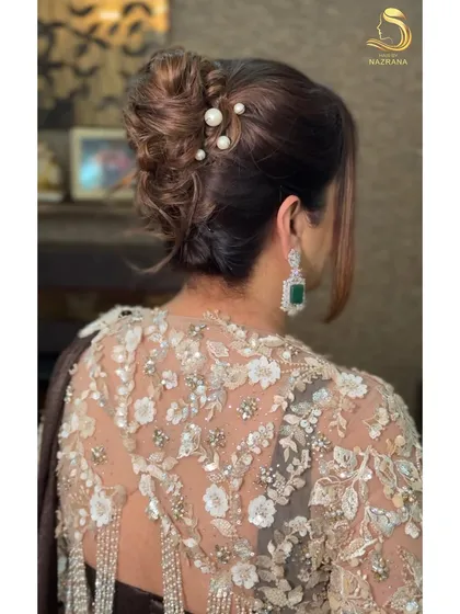 A close-up of the pearl pins in the textured updo.