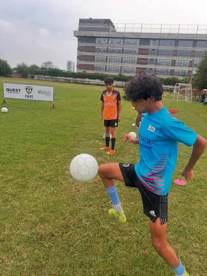 A player practicing his first touch and control, a crucial skill for any aspiring footballer.