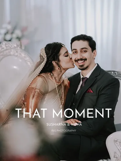 A sweet kiss on the cheek. This candid photo from their reception captures a spontaneous moment of affection and the groom's happy reaction.