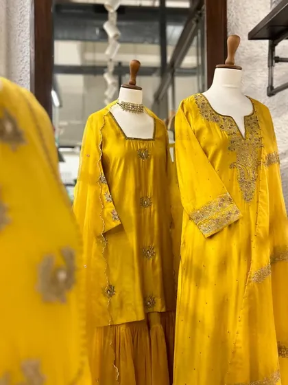 Another view of the yellow and white collection, highlighting the fine craftsmanship and luxurious fabrics.