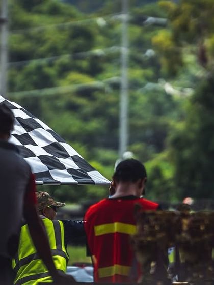 The checkered flag waves, marking the end of another hard fought race. This is the symbol of every racer's ultimate goal.