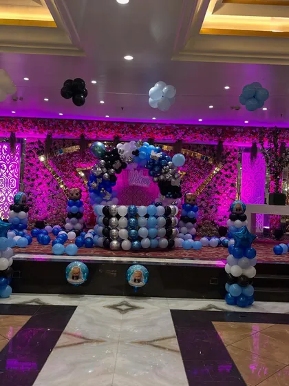 The main stage decoration for the 'Welcome Baby' event, featuring a Boss Baby theme with multiple balloon arrangements.