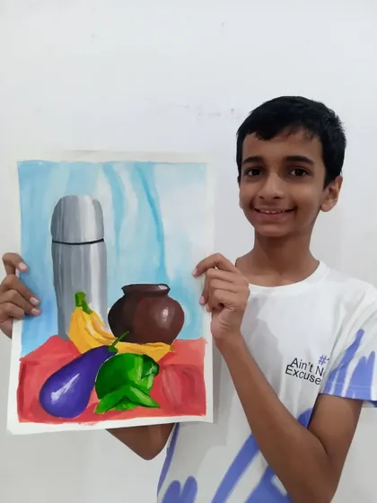 Ishan, a 9th standard student, with his object drawing done in watercolor. This still life composition shows his skill in painting realistic textures and reflections on different surfaces.