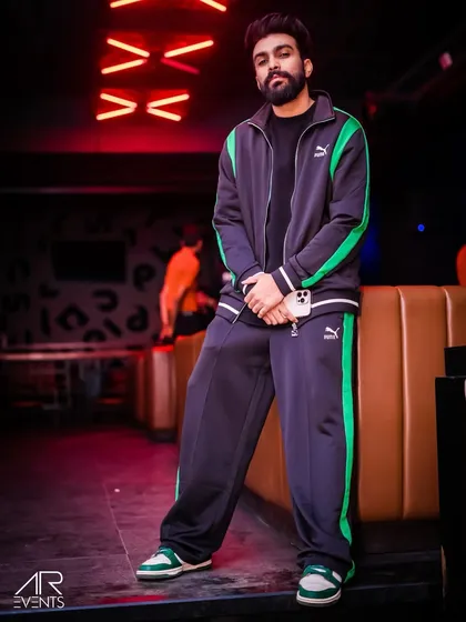 Rocking a classic tracksuit look for a Thursday night gig. My style is part of my brand, and I always bring a fresh look to my shows.