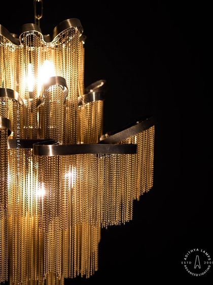 This chandelier makes a bold statement with its cascading antique gold chains. The layers of chains create a fluid, waterfall-like effect that beautifully diffuses the light, adding texture, warmth, and a touch of vintage glamour to your interior.