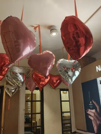 A closer look at the Valentine's Day decor near the salon's nail bar. I used a mix of red, pink, and silver foil balloons to create a romantic and chic color palette that complemented the store's existing interior.