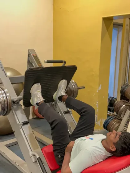 The leg press machine is a core piece of equipment for building lower body strength. Here, a member focuses on his form during a set. We have a wide variety of machines to target every major muscle group effectively.