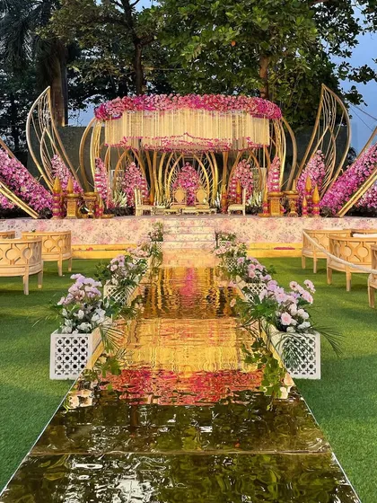 Presenting my signature Lotus Mandap, where design is inspired by the bloom itself. The golden mirrored aisle reflects the sky, creating a path that feels like walking on water towards your new beginning.