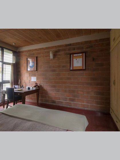 Another angle of the bedroom, showing the study nook and the light coming in from the window.
