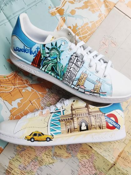 The other side of the travel-themed Stan Smiths, featuring detailed paintings of landmarks from Mumbai, London, and New York.