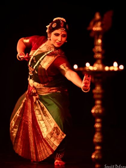 Performing at the India Habitat Centre for 'Soukariyam - The Aesthetic'. The traditional lamp, or 'diya', is an integral part of the stage setting, symbolizing the light of knowledge and art.