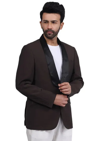 A model wears a brown blazer with a satin lapel, creating a sophisticated evening look. This image is perfect for a brand's lookbook or a campaign focused on special occasion wear.