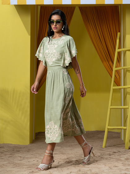 A walking shot capturing the movement of a dress from Boho-Chic's "Palmera" collection on our in-studio sand set.