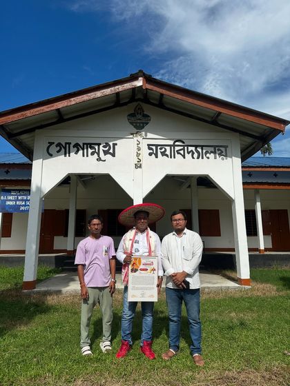 Standing proudly in front of Gogamukh College with organizers, holding a certificate of appreciation after a successful workshop.