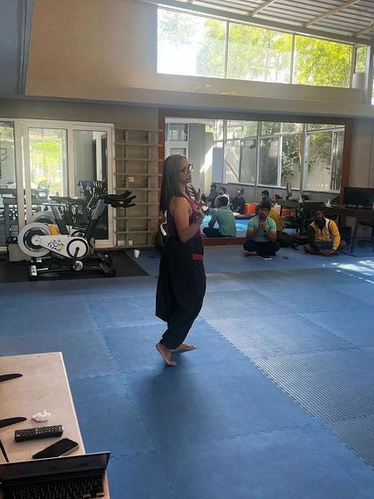 Our wellness mentor guiding the team through an exercise. These sessions provide invaluable tools for managing stress and improving self-awareness.