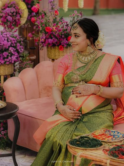 Draping the lovely Pearle Maaney for her Valaikappu. The green and pink Kanchipuram silk saree was the perfect choice for this joyous occasion.