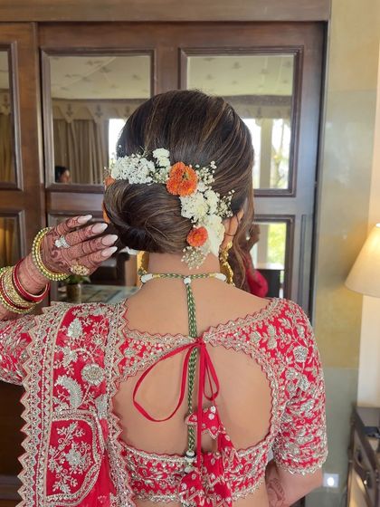 A clear, centered shot of the floral bridal bun, showing the neatness of the bun and the beauty of the flower arrangement.