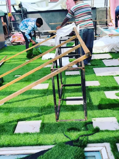 Work in progress, laying down lush 50mm grass for a temporary rooftop event space.