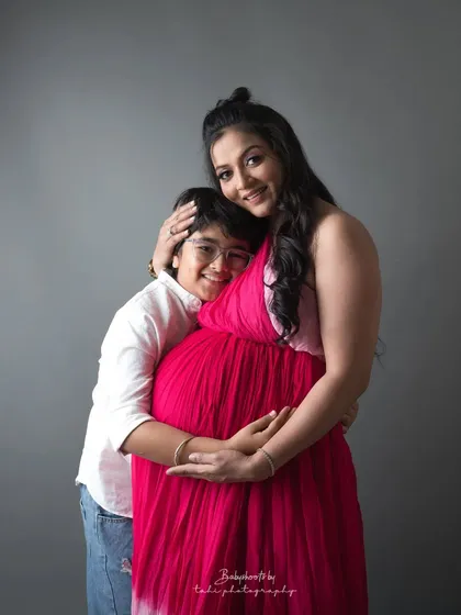 A mother embraces her son while expecting her next child. A beautiful portrait of a soon-to-be big brother and his loving mom.