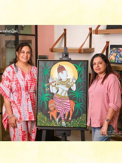 A student and I pose with her large, stunning painting of Lord Krishna, a testament to her progress and dedication in the studio.
